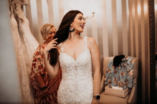 Young woman trying on wedding dress